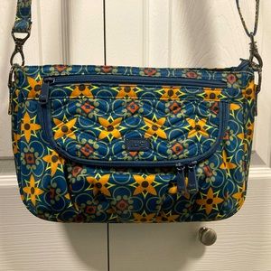 NWOT lug Mambo-Tiles Teal with RFID protection in front pocket. Max strap 59”